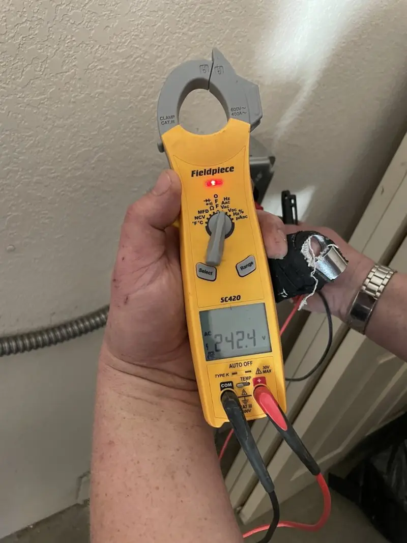 Voltage testing with clamp meter during Electrical Installation Services in Alexandria